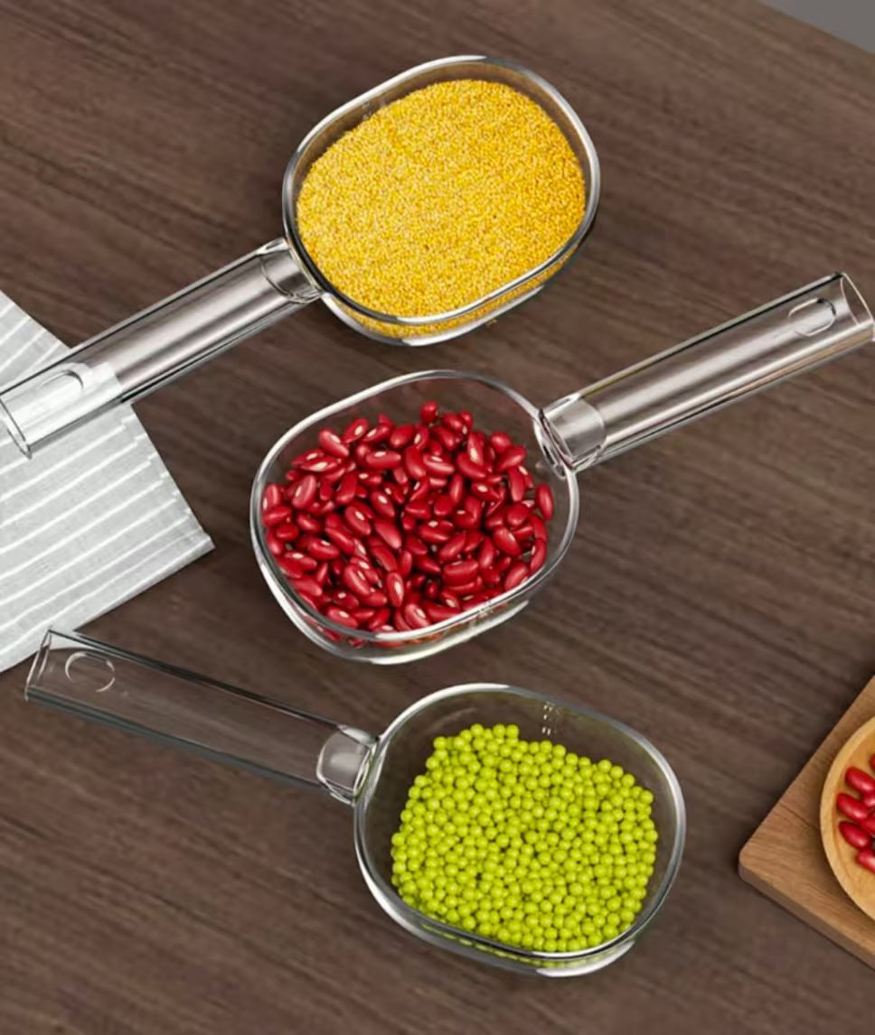 Acrylic  scoop with a long handle and clearly marked measurements